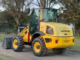 Photo 1. New Holland W80C Loader