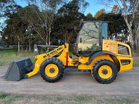 Photo 3. New Holland W80C Loader